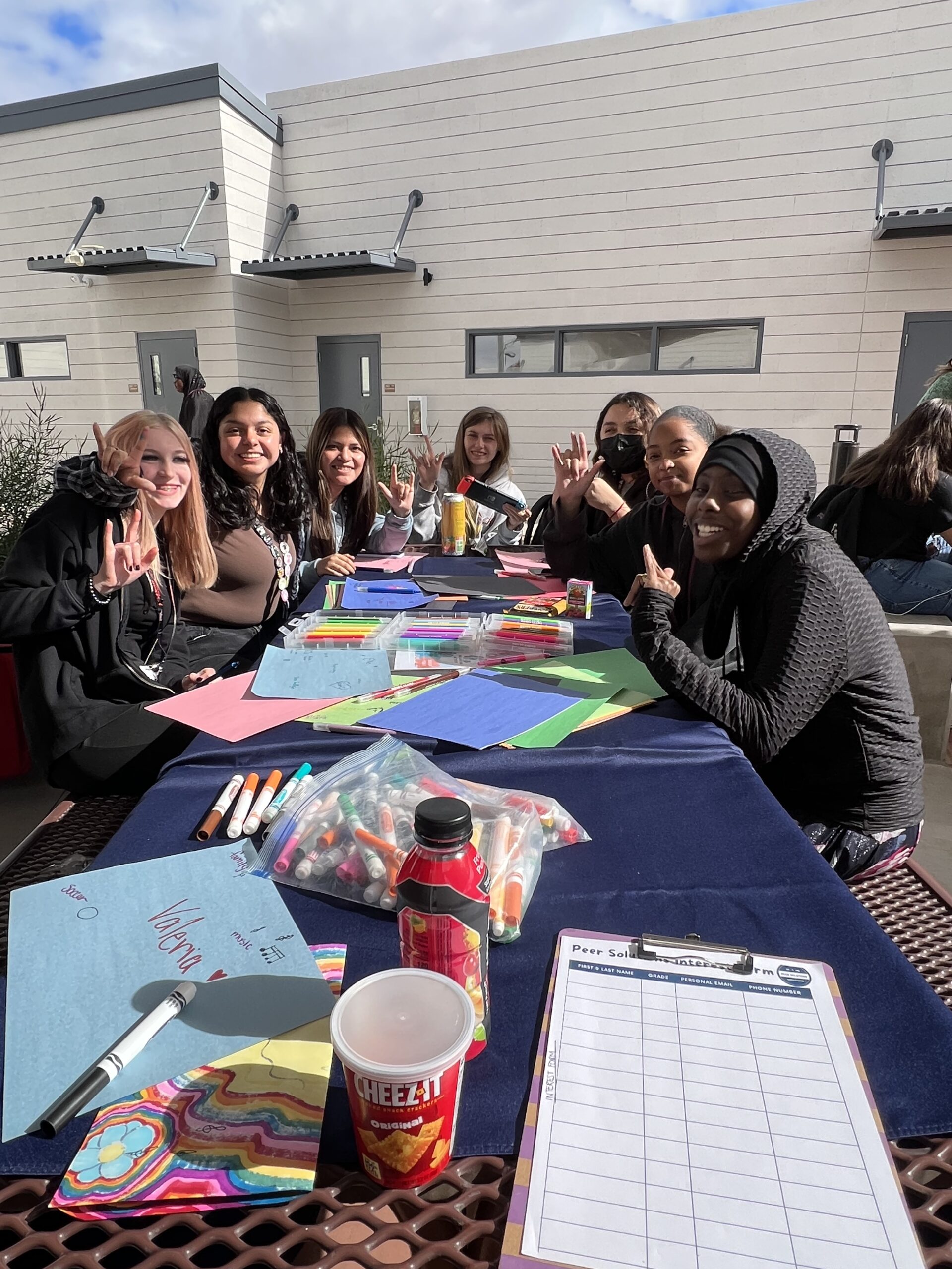 a group of people sitting around a table.