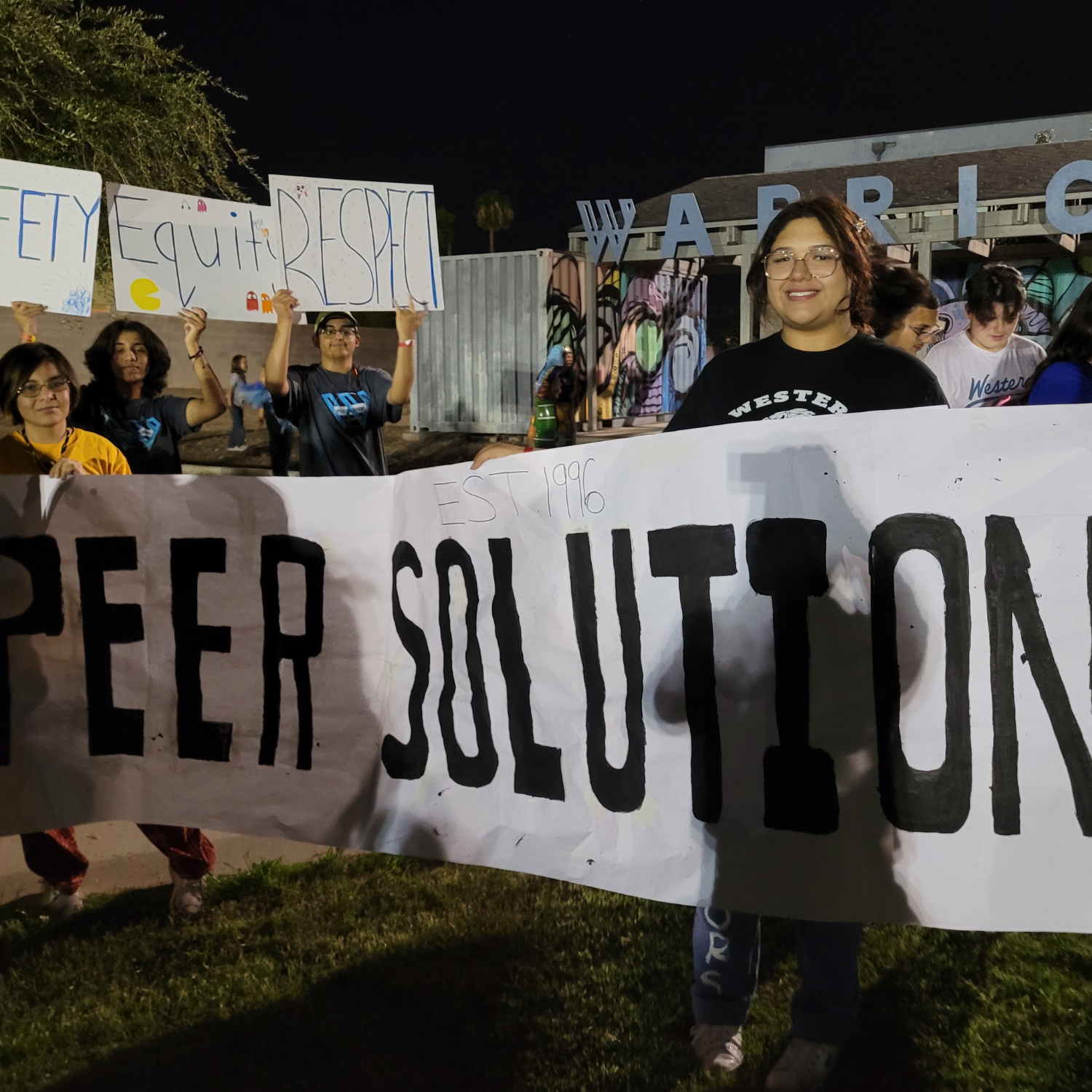 a group of people holding a sign that says peer solution.