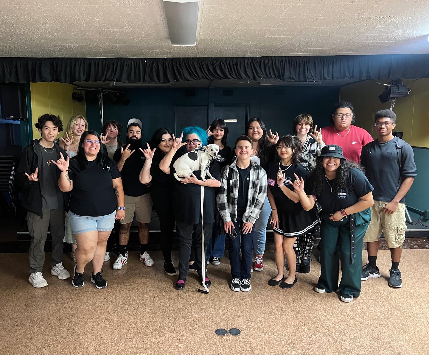 a group of people posing for a picture in a room.